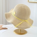 Detail of a beige woven straw sun hat featuring a wavy wide brim and yellow tulip accent - Beige with Yellow Ribbon