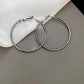 Macro detail of large silver metallic hoop earrings on beige silk fabric backdrop - 5cm / Gunmetal