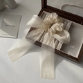 Elegant champagne organza bow hair scrunchie with long ribbons on a wooden box - Beige Hair Tie