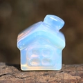 Macro shot of an opalite house ornament placed on natural tree bark with soft lighting - Synthetic Opal