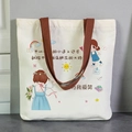 Off-white canvas tote bag with brown straps and cute cartoon girl illustrations - Because I Love to Smile