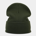 Close-up of dark green ribbed knit texture and folded cuff on a warm winter beanie - Olive Green