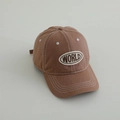 Detail of a brown washed denim baseball cap featuring white stitching and WORLD embroidery - Letter WORLD / Orange