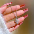 Detailed view of cross pendant featuring baguette zircons and a small golden center cross - Silver Clear Gemstone Cross Style (G535)
