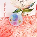 Detail of dreamlike purple starry planet phone socket grip on pink raffia background - Expanding Stand / White Planet