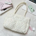 Detailed top view of white quilted tote bag with heart embroidery and daily essentials - Multicolor Gourd Heart