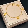 Elegant 18k gold butterfly charm bracelet with crystal accents on velvet jewelry box - Gold Three Butterflies Double Diamonds (5284)