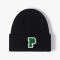 Black knit beanie with green letter P patch embroidery in a ribbed college style - Black
