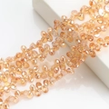 Macro shot of amber moon-shaped crystal glass beads for DIY jewelry making and crafts - Amber Gold