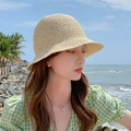 Chic beige straw bucket hat for women featured in a sunny beach vacation setting - M (56-58cm) / Apricot