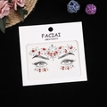 Detailed view of red and clear crystal face jewels on eye makeup template card - Red Series