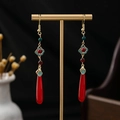 Traditional red auspicious cloud drop earrings with pearls on a golden display stand - Red Gold Green Cloud Dangle