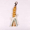 Handwoven yellow daisy keychain featuring cotton tassels and a durable metal clasp detail - Earthy Yellow