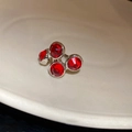 Close-up of four red round gemstones set in silver metal square earrings on white ceramic - 38# Silver Red Gem Ear Clip (Single)