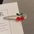 Golden cherry hair clip with red rhinestones and green crystal leaves on a card - Cherry Rhinestone Hair Clip