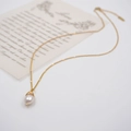 Elegant gold chain necklace with a white teardrop pearl pendant and wire-wrapped detail - Single Baroque Pearl Pendant Necklace