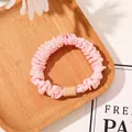 Detail of pink satin scrunchie with elegant pleats and a unique square resin charm - Satin Solid Pink