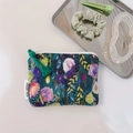 Close-up of oil painting floral fabric pouch with green tassel and brand label - Green Purple Tulip