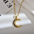 Macro shot of gold moon pendant featuring white zircons and black oil drip details - Black