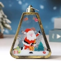 Close-up of a vintage gold Christmas lantern featuring a Santa Claus and tree scene - Antique Gold Santa