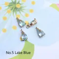 Detail view of water drop-shaped lake blue glass charms with gold-plated metal edges - 4*8mm / Lake Blue