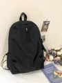 Minimalist black high-capacity backpack with cord zipper pulls in a campus lifestyle setup - Black