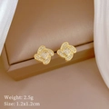 Macro detail of gold spinning clover stud earrings with crystals on display - Stud Earrings(C224)