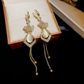 Vintage gold drop earrings featuring cat eye stone, floral accents and long metal tassels - Gold Cat Eye Tassel Style