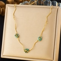 Golden stainless steel necklace featuring turquoise bead flowers on a jewelry box - Turquoise Flower Decoration Style (N3293)