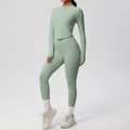Detail of high-waist sage green yoga set showing zip-up jacket with V-shape hem - S / Basil Green