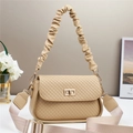 Detail view of beige plaid crossbody bag with pleated handle and golden twist lock clasp - Beige