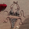 Two-piece leopard print bikini set with halter top and side-tie bottoms on woven mat - XS / Leopard Brown