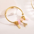 Golden beaded bracelet with Eiffel Tower and heart charms featuring pink resin beads - Gold Eiffel Tower