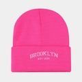 Close-up of pink knit beanie with white Brooklyn embroidery and ribbed texture - Rose Red