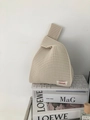 Detail of beige knitted knot bag showing openwork mesh texture and brand woven label - Off White