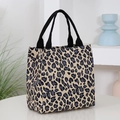 Large capacity leopard print tote bag with black handles in a modern minimalist setting - Yellow Small