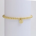 Macro detail of golden beaded bracelet featuring a round pendant engraved with letter K - Letter K (DB240603-K)
