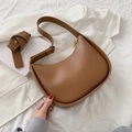 Brown leather crescent saddle bag with adjustable strap and stylish half-moon design - Brown