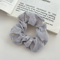 Light purple tulle hair scrunchie with golden stars pattern on a book page - FQ1068C Grey Star Scrunchie