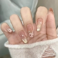Macro view of almond press-on nails with 3D pink bow, star patterns, and pearl accents - Handmade Nails (Size M/10 Pieces Pack) / Outstanding and Unrestrained