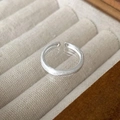 Minimalist silver twist ring with brushed matte finish in a beige jewelry box - Matte Texture Open Ring (J3286)