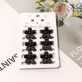 Set of six mini black flower hair claw clips for girls on a decorative display card - Solid Black Five-Leaf Flower