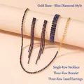 Detail of gold jewelry set with dark blue rhinestones including choker, bracelet and earrings - Gold Base Blue Rhinestone 3-Piece Set