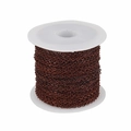 Close-up of bronze flat O-chain roll for jewelry making on a white plastic spool - Antique Red Copper