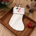 Cream white knitted Christmas stocking featuring a red embroidered letter Z and holly - Letter Z