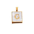 Macro detail of square gold-plated pendant with white shell inlay and letter G design - Gold G