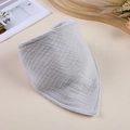 Detailed view of grey muslin cotton baby bandana bib with soft white stitched edging - Light Gray