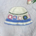 White hand-knitted bucket hat with pink, blue, and green crochet floral patterns - M (56-58cm) / Eight Butterflies Basin Hat