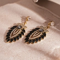 Close-up of vintage gold leaf earrings featuring black gemstones and clear crystals - Silver Pin Black Rhinestone Flower Leaf Dangle Earrings