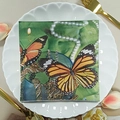 Square floral paper napkin featuring monarch butterflies and gold chains on a ceramic plate - Butterfly & Pearl (1067)